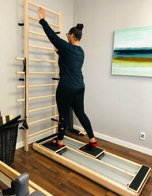 patient using pilates equipment